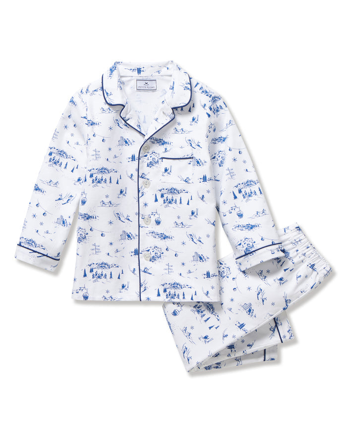 Kid's Twill Pajama Set in Chalet Toile, a white pajama set with blue piping and scenic print, includes a long-sleeve button-up top and matching pants, shown laid flat on a white background.