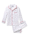 The Kids Twill Pajama in Coastal Charms by Petite Plume is flame-retardant, made from yarn-dyed cotton, and features a white design with red piping, adorned with small bicycle and Eiffel Tower prints. It includes a long-sleeve button-up top with a chest pocket and matching pants.
