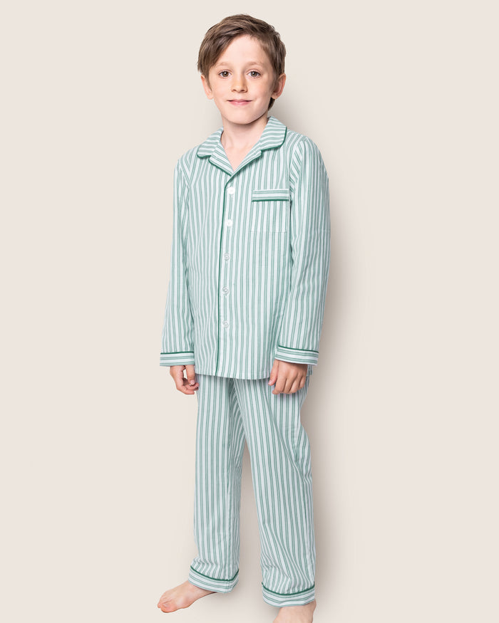 Close-up of Petite Plumes Kids Twill Pajama Set in Emerald Ticking, showcasing vertical blue and white stripes with green trim. The classic French ticking pattern includes buttons, a pocket, and visible cotton sleepwear texture and stitching details.