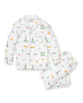 The Kids Twill Pajama Set in New York! New York! by Petite Plume features white pajamas with colorful prints of the Statue of Liberty, Empire State Building, taxis, and Brooklyn Bridge. The set includes a button-up shirt and pants adorned with pizza slices, pretzels, and New York script.