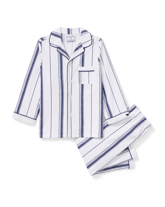 Kid’s Twill Pajama Set in Parlor Stripe, displayed laid flat on a white background, features a long-sleeved button-up top with a chest pocket and matching pants in white with navy blue vertical stripes.