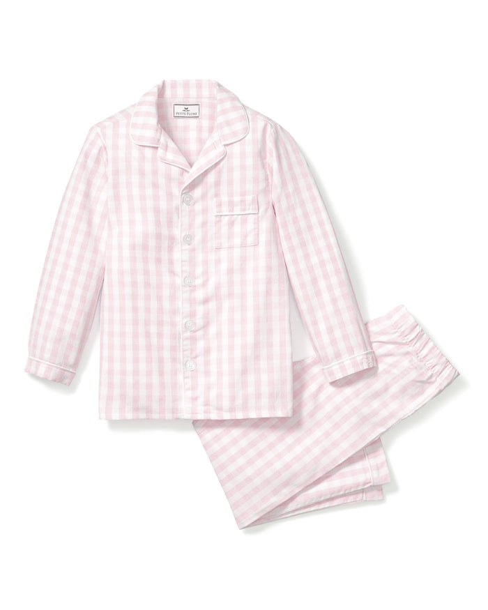 The Kids Twill Pajama Set in Pink Gingham by Petite Plume is crafted from yarn-dyed cotton and features a pastel pink and white gingham print. The long-sleeve button-up top includes a chest pocket, while the matching pants have an elastic waistband for comfort.