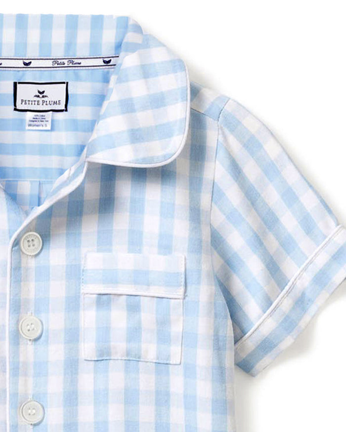 The Kid's Twill Pajama Short Set in Light Blue Gingham features a button-up short-sleeve top with a chest pocket and matching elastic-waist shorts in a classic gingham check pattern.