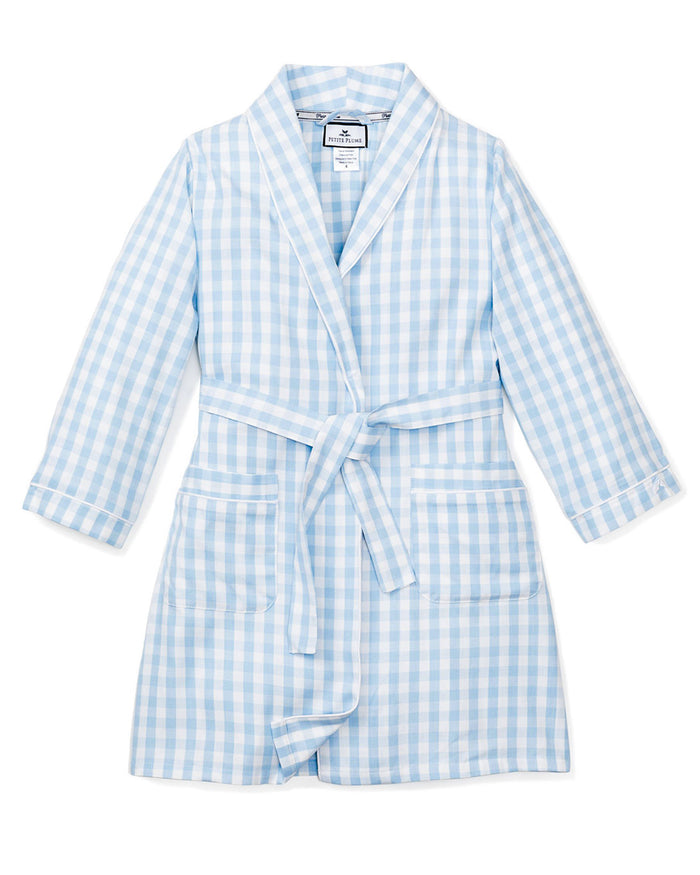 The Kid's Twill Robe in Light Blue Gingham features a soft gingham pattern, long sleeves, shawl collar, front pockets, and a matching belt at the waist for comfort and style.