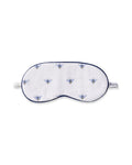 The Petite Plume Kids Twill Sleep Mask in Buzzing Bees is a white mask with blue and yellow bees pattern, dark blue trim, an elastic strap for comfort, and offers monogramming for personalization.