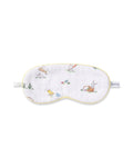 A young boy wears a Kid's Twill Sleep Mask in Easter Frolic, featuring colorful animal and nature prints, along with matching white pajamas. He smiles softly against a plain, light background.
