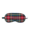The Kid's Twill Sleep Mask in Kensington Tartan features red, green, yellow, blue, and white plaid, an elastic strap, and a small white PETITE tag on the right side.