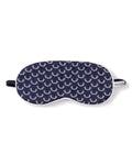 The Kids Twill Sleep Mask in Nordic Antlers by Petite Plume features a navy blue design with white antlers, a black elastic strap, and a PETITE fabric tag, ideal for matching with luxurious sleepwear.