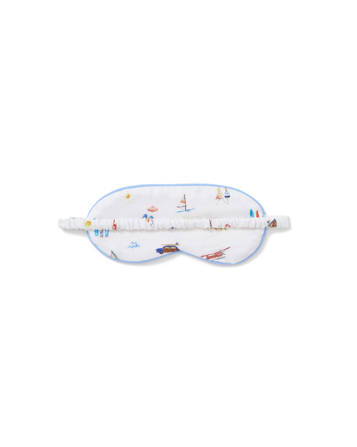 Kid’s Twill Sleep Mask in Summer Nostalgia: A white sleep mask featuring colorful nautical and beach-themed illustrations, such as sailboats and beach balls, finished with a gathered elastic strap.
