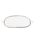 The Kids Twill Sleep Mask in White with Navy Piping by Petite Plume offers a touch of luxurious sleepwear. This oval-shaped mask is perfect for restful nights and pairs elegantly with other bedtime accessories, set gracefully against a white background.