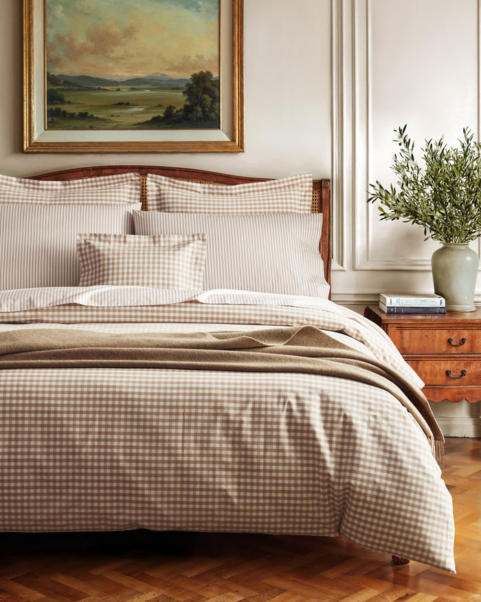 The Luxe Premium Percale Bed Sheets in Camel Ticking feature beige and white stripes and include a flat sheet, fitted sheet, and two pillowcases, all neatly folded and displayed on a white background.