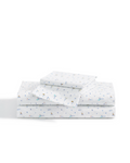 A neatly folded stack of Luxe Premium Percale Bed Sheets in Letters and Lullabies, featuring a playful, multicolored alphabet and animal print design on a plain white background.