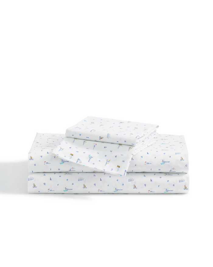 A neatly folded stack of Luxe Premium Percale Bed Sheets in Letters and Lullabies, featuring a playful, multicolored alphabet and animal print design on a plain white background.