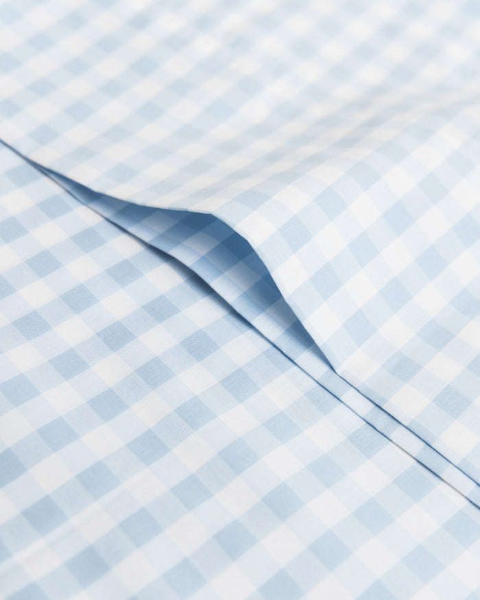 Blue and white checkered bedding set on a white background
