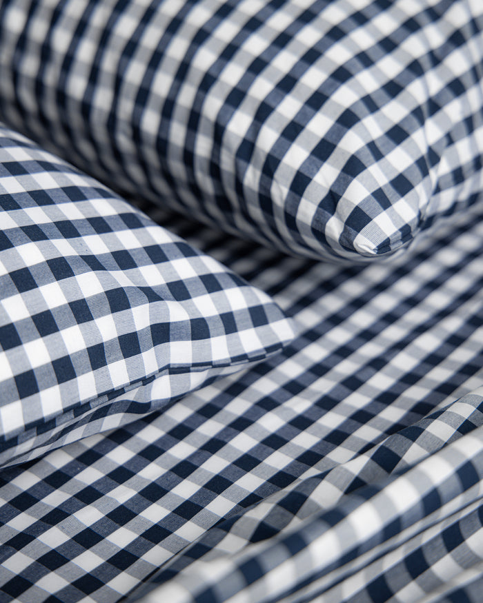 Blue and white checkered bedding set on a white background