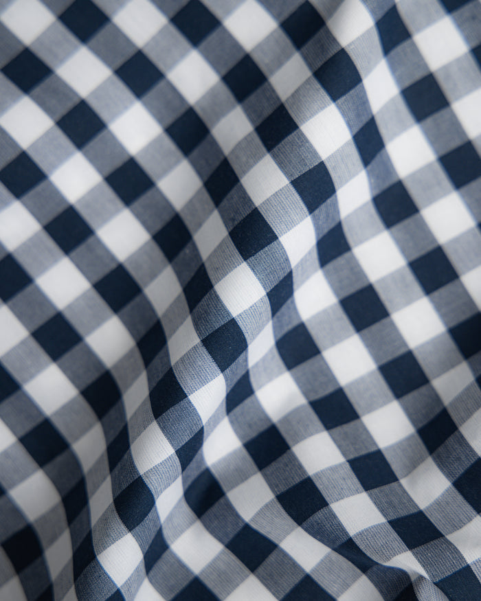 Blue and white checkered bedding set on a white background