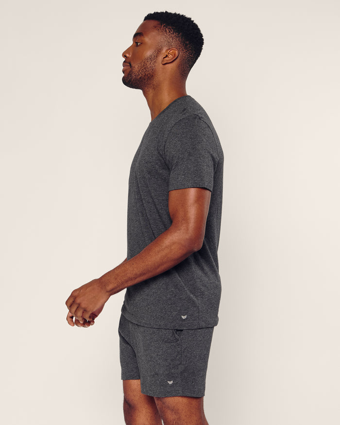 A man stands in profile against a plain background, wearing Petite Plumes Mens 5 Pima Short in Dark Heather Grey, crafted from luxurious pajamas-quality Peruvian Pima cotton.
