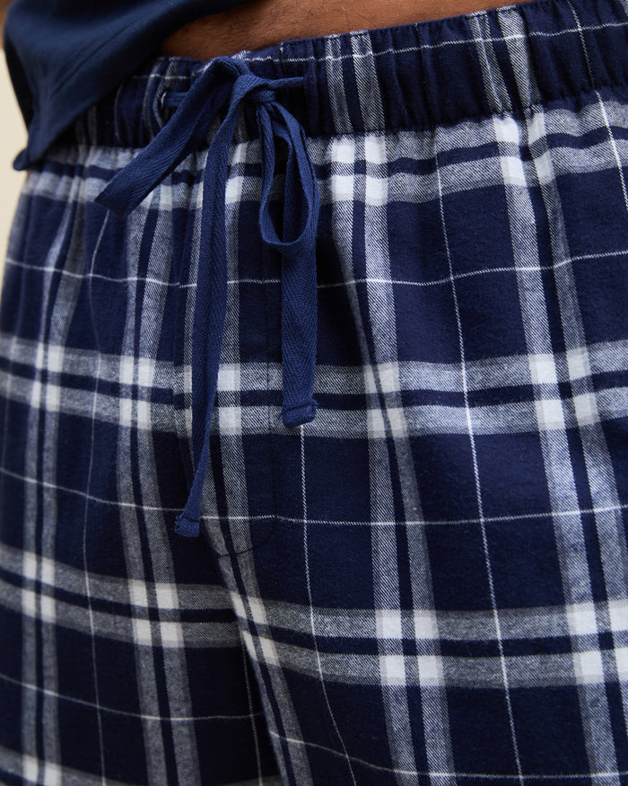 Men's Brushed Twill Pajama Pant in Oxford Tartan featuring navy blue and white plaid, an elastic waistband, and a drawstring, shown laid flat on a white background.