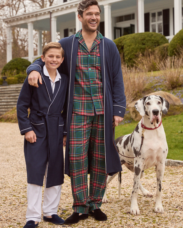 The Men's Brushed Twill Pajama Set in Kensington Tartan features a button-up long-sleeve shirt and matching drawstring pants in a classic green, red, yellow, and blue plaid pattern.