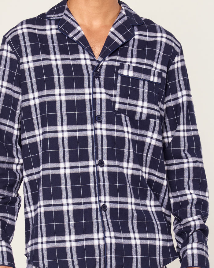 The Men's Brushed Twill Pajama Set in Oxford Tartan includes a two-piece navy and white plaid design with a long-sleeved button-up shirt featuring a chest pocket and matching drawstring pants.