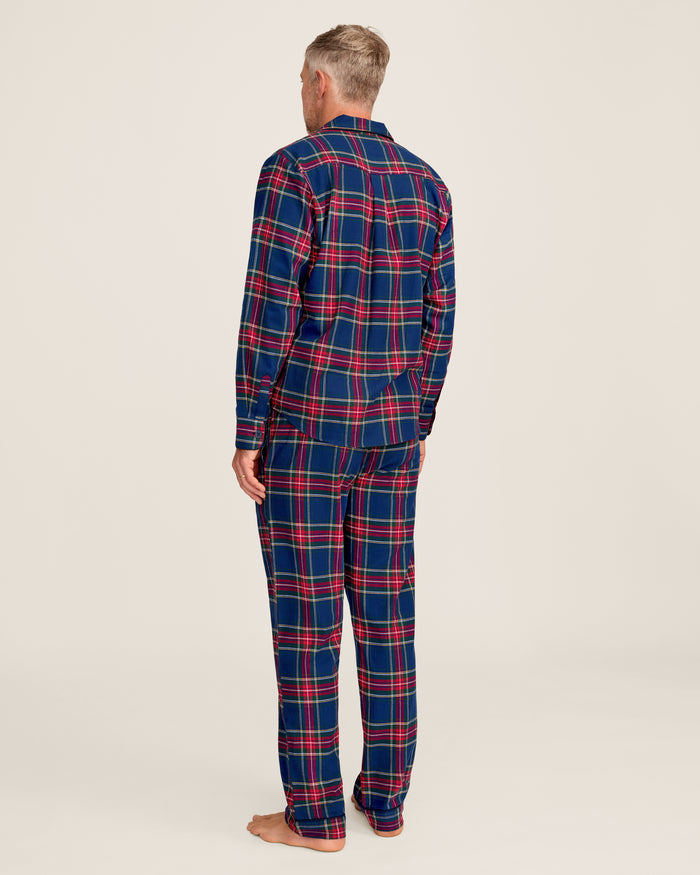 Close-up of a lightweight flannel plaid fabric with red, green, blue, and yellow stripes. The pattern is from Petite Plumes Mens Brushed Cotton Pajama Set in Windsor Tartan, featuring a notched lapel and a single black button.