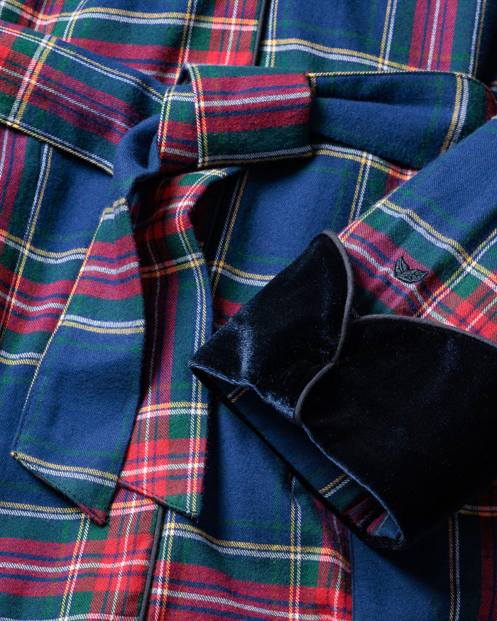Close-up of the Mens Brushed Cotton Velvet Trim Robe in Windsor Tartan by Petite Plume, showcasing soft flannel fabric with red, green, yellow, and blue plaid across 100% cotton. Features include a tied belt and dark navy velvet collar and cuffs for a luxurious blend of textures and colors.