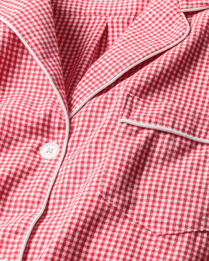 A close-up of Petite Plumes Mens Flannel Pajama Set in Red Mini Gingham reveals the finest quality cotton fabric with white piping, a button, and a pocket, exemplifying classic pajama set design.