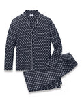 Men’s Lightweight Pima Pajama Set in Captain’s Compass showcases a navy blue design with a white geometric circular pattern, featuring a long-sleeve button-up top with a chest pocket and matching pants, both finished with white piping accents.