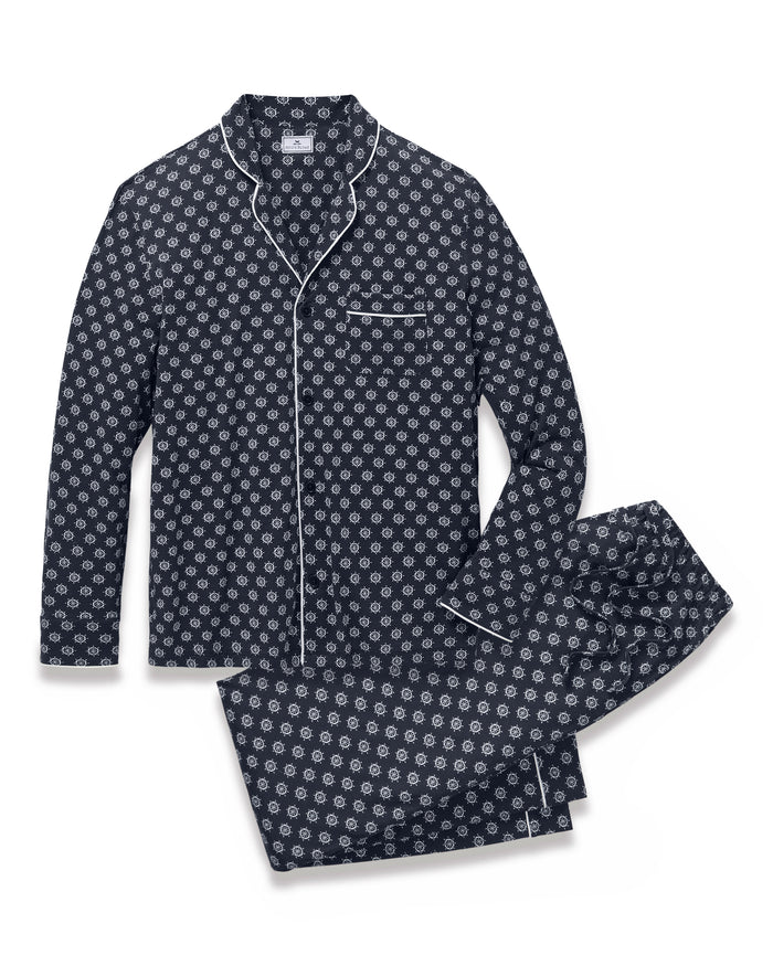 Men’s Lightweight Pima Pajama Set in Captain’s Compass showcases a navy blue design with a white geometric circular pattern, featuring a long-sleeve button-up top with a chest pocket and matching pants, both finished with white piping accents.