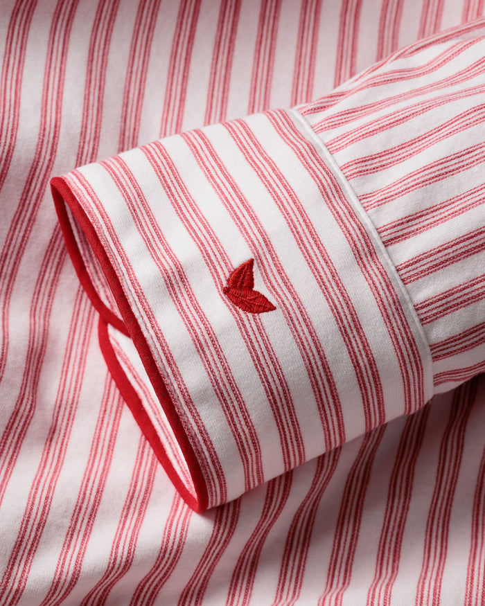 Close-up of a red and white striped sleeve crafted from soft Pima cotton in the Mens Pima Pajama Set in Antique Red Ticking by Petite Plume, featuring embroidered detailing and precise tailoring for timeless pajama luxury.
