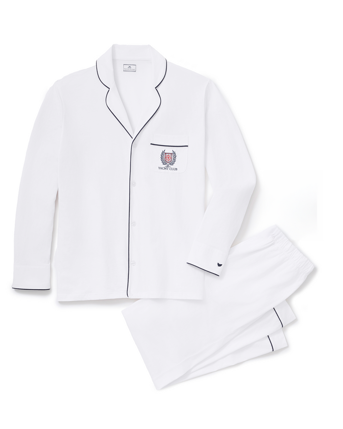 Men’s Pima Pajama Set in White with Yacht Club Embroidery features a white long-sleeve, button-down top with black piping and an embroidered yacht club crest on the chest pocket. The relaxed-fit pants also have black piping at the hem.