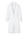 The Mens Pima Robe by Petite Plume, in white with navy piping, features long sleeves and a waist tie belt. Made from luxurious Peruvian Pima cotton, it offers exceptional softness and comfort. It includes two front pockets accented with navy trim.