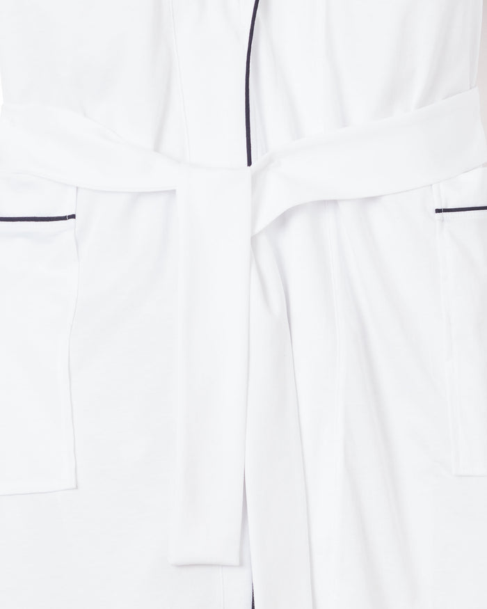 Close-up of the Mens Pima Robe in White with Navy Piping by Petite Plume, showcasing a tied waist belt and dark piping. Made from opulent Peruvian Pima cotton, this robe features double pockets and soft, smooth fabric.