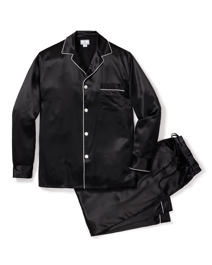 The Mens Silk Pajama Set in Black by Petite Plume is crafted from luxurious mulberry silk and features white piping. This set includes a long-sleeve button-up shirt with a chest pocket and matching elastic-waist pants, combining elegance and comfort effortlessly.