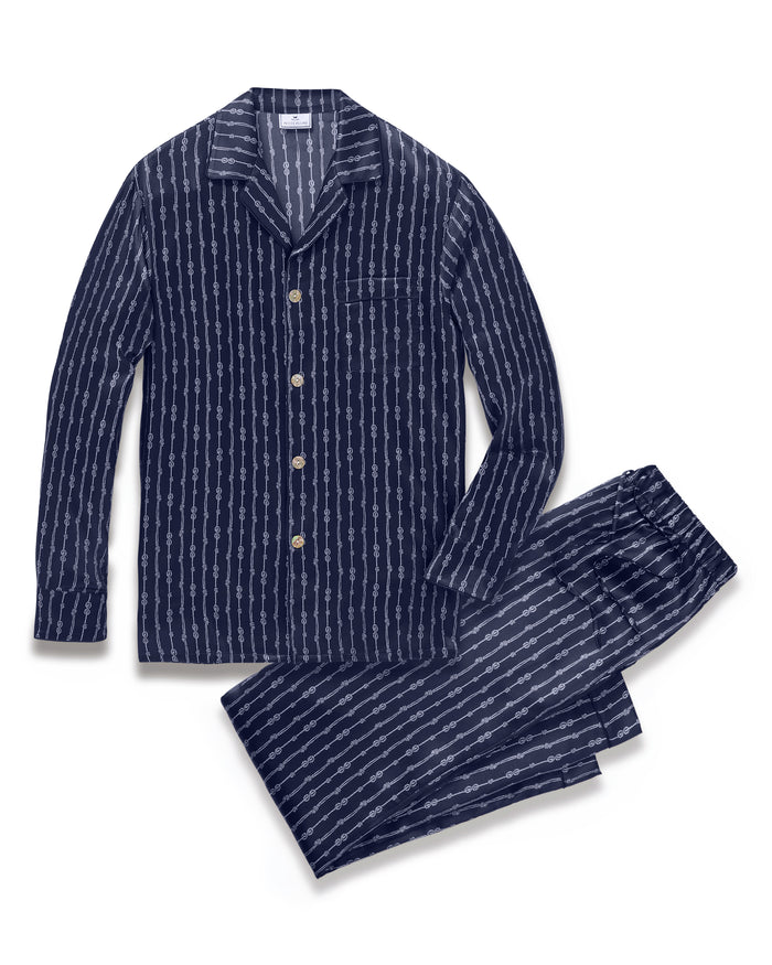 Men’s Silk Pajama Set in Nautical Knots featuring a navy blue button-up long-sleeve top and matching pants, both accented with a white horizontal stripe pattern.