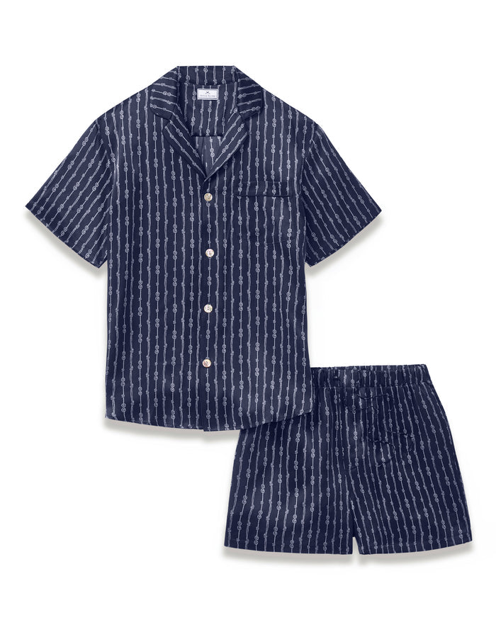 Men’s Silk Pajama Short Set in Nautical Knots features a navy blue short-sleeve button-up shirt with a chest pocket and white vertical stripe pattern, paired with matching shorts that have an elastic waistband.