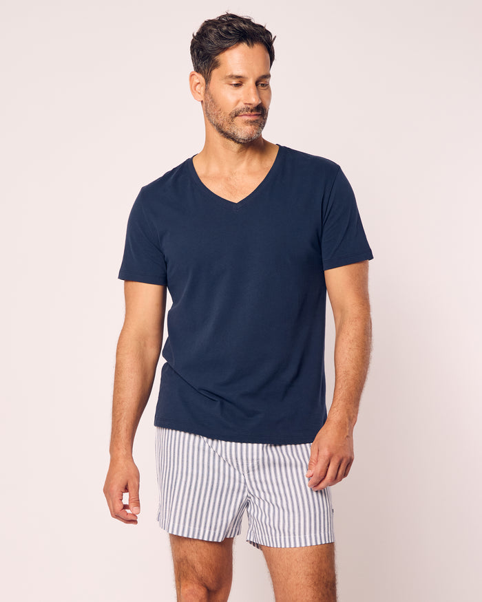 A man with short dark hair and a beard wears navy Petite Plume Mens Twill Boxers, styled against a plain light background as he looks slightly to the side.