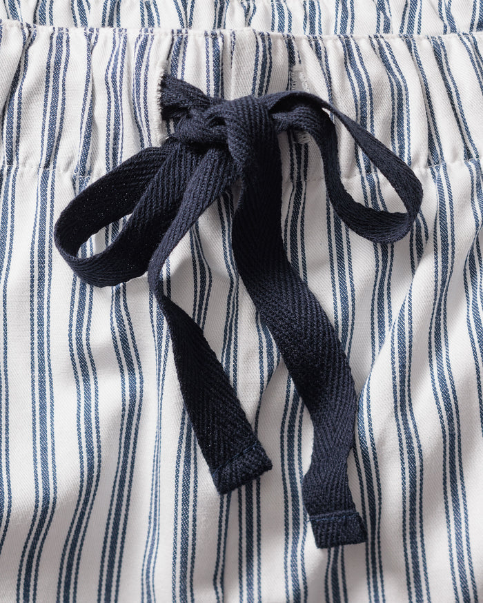 A close-up of the fabric drawstring on Petite Plumes Mens Twill Pajama Pants shows an elegant black bow against navy blue stripes on pristine white, traditional French ticking.