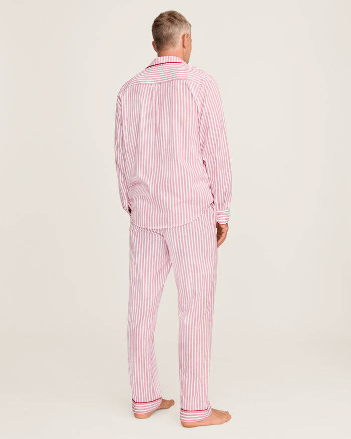 Close-up of Petite Plumes Mens Twill Pajama Set in Antique Red Ticking, featuring pink and white vertical stripes, a collar, a pocket with matching trim, and a single white button. Perfect for cozy relaxation.