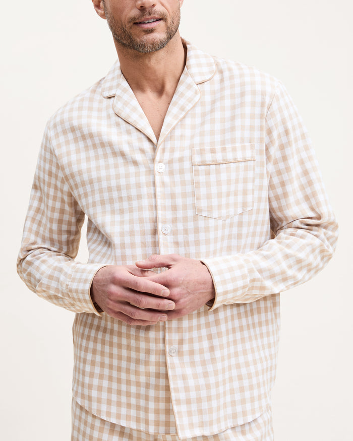 The Men's Twill Pajama Set in Camel Gingham includes a long-sleeve, button-up top with a chest pocket and matching pants, both in a beige and white gingham check pattern.