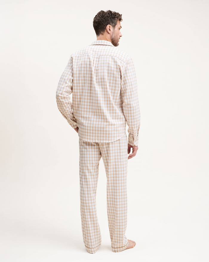 The Men's Twill Pajama Set in Camel Gingham includes a long-sleeve, button-up top with a chest pocket and matching pants, both in a beige and white gingham check pattern.