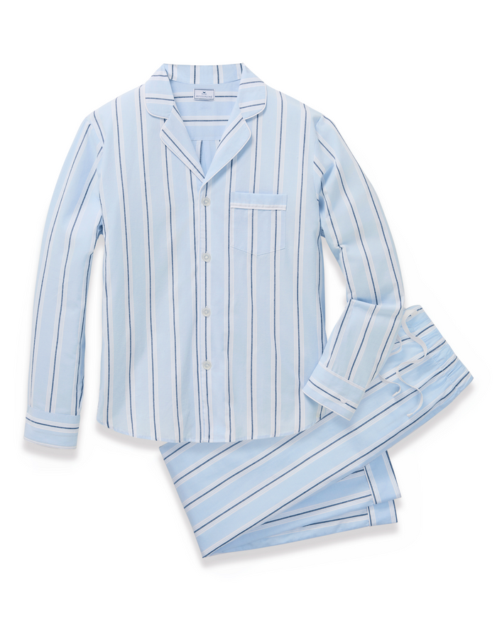 Men’s Twill Pajama Set in Coastal Stripe, featuring a light blue background with white and dark blue vertical stripes, long sleeves, pants, a chest pocket, and white buttons.