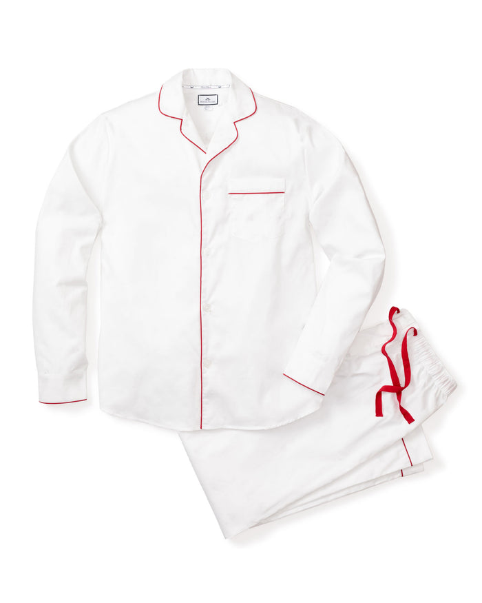 The Mens Twill Pajama Set by Petite Plume offers luxurious sleepwear with elegant red piping. The white long-sleeve top has a chest pocket, and the matching pants feature a stylish red drawstring waist.