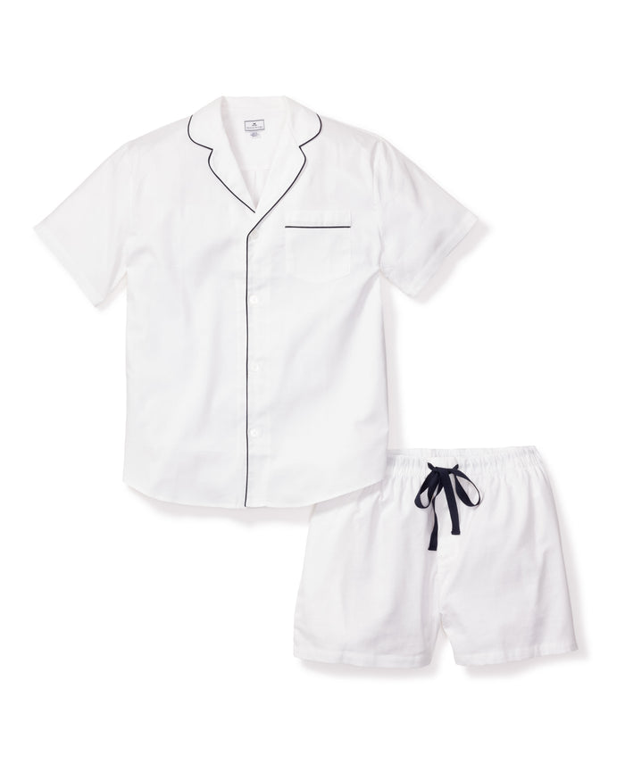 Experience luxury sleepwear with Petite Plumes Mens Twill Pajama Short Set in white featuring navy piping. The top includes a collar, button front, and chest pocket while the shorts offer an elastic waistband and navy drawstring for comfort.