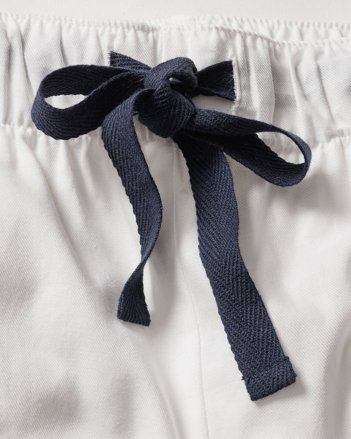 Close-up of a navy blue drawstring tied in a bow on Petite Plumes Mens Twill Pajama Short Set, White with Navy Piping. Made from 100% cotton, the textured drawstring complements the smooth appearance of this luxury sleepwear.