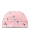 The Petite Plume x Eloise Baby Pima Hat in Eloise Adventures features soft pink fabric with white polka dots, playful girl and dog illustrations, and a pink embroidered butterfly on the cuff.