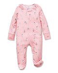 The Petite Plume x Eloise Baby Pima Romper, featuring a pink design with ruffles and playful prints, is displayed alongside the Eloise Hardcover Children’s Book.