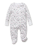 The Petite Plume x Eloise Baby Pima Romper in Eloise Suite Soireé is a white, long-sleeved onesie with a zipper and an all-over print of cartoon dogs, bones, leashes, and paw prints in pink, black, and gray.