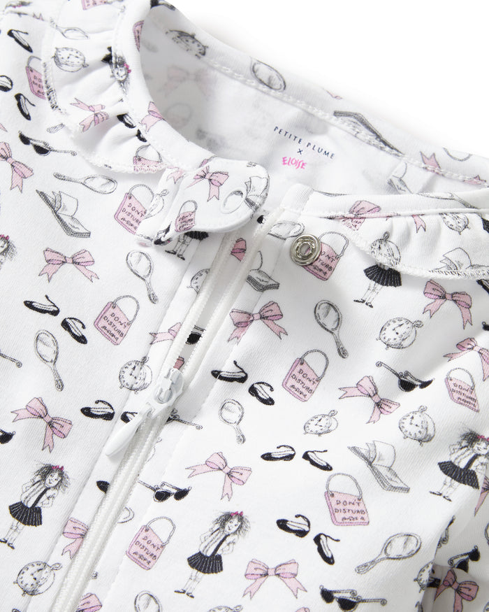 The Petite Plume x Eloise Baby Pima Romper in Eloise Suite Soireé is a white, long-sleeved onesie with a zipper and an all-over print of cartoon dogs, bones, leashes, and paw prints in pink, black, and gray.