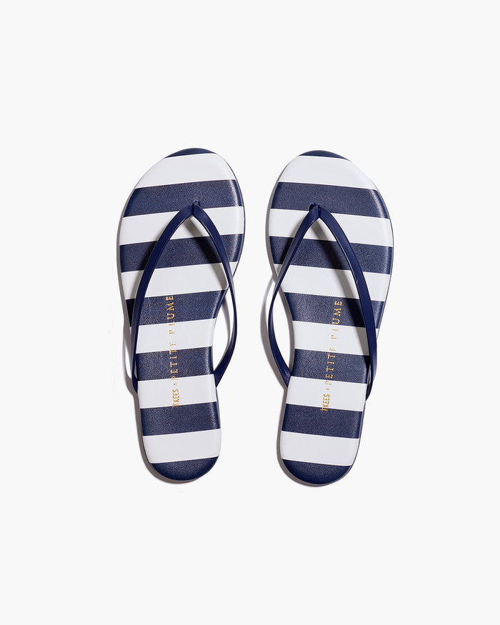 The Petite Plume x TKEES Lily Sandal in Cabana Stripe features navy blue and white horizontal stripes on the footbed with navy straps, shown side by side on a white background.